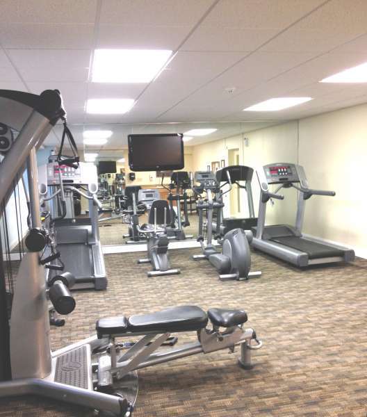 A fully equipped gym at Crossings at Stanbridge apartments for rent