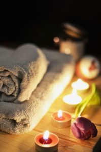 Spa candles next to a rose