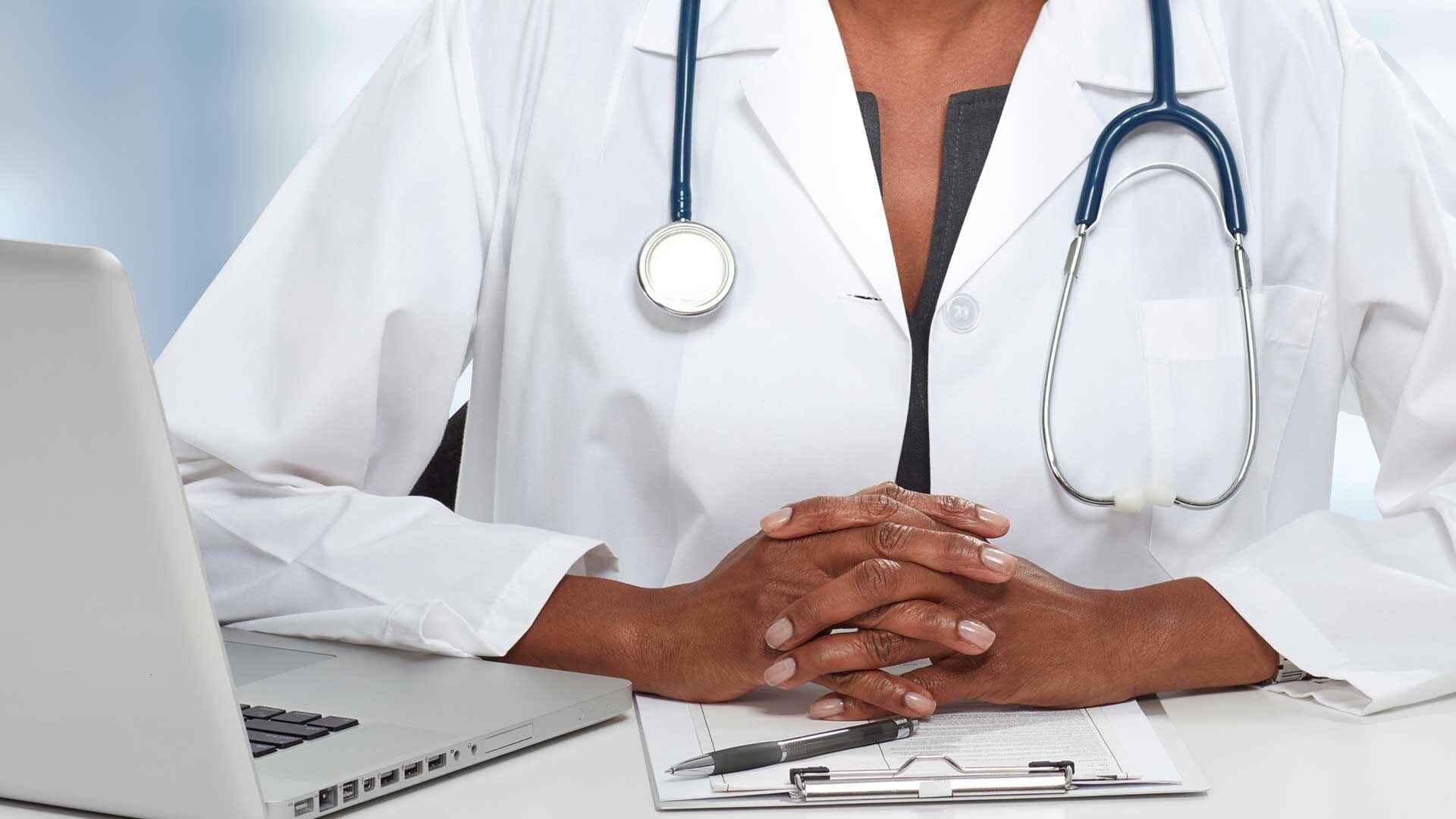 Doctor wearing a stethoscope at her desk