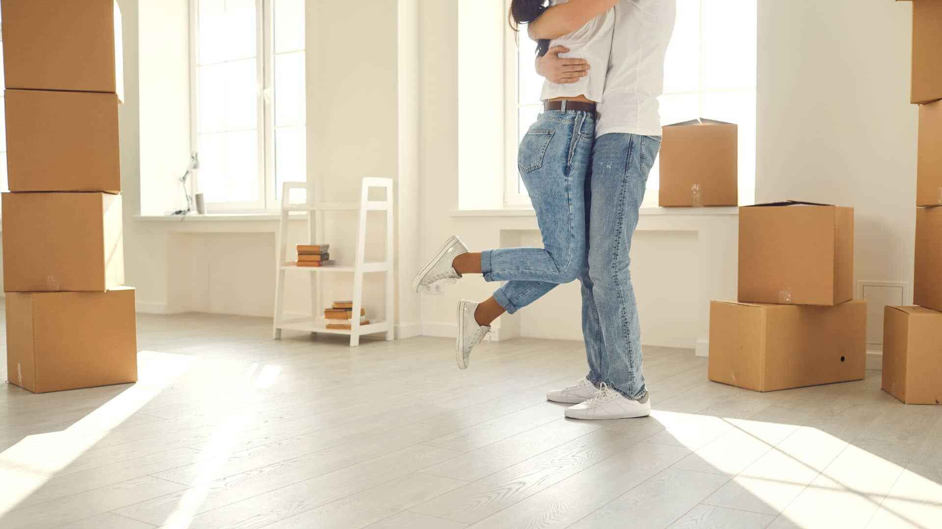 Couple embracing as they move into their new apartment home