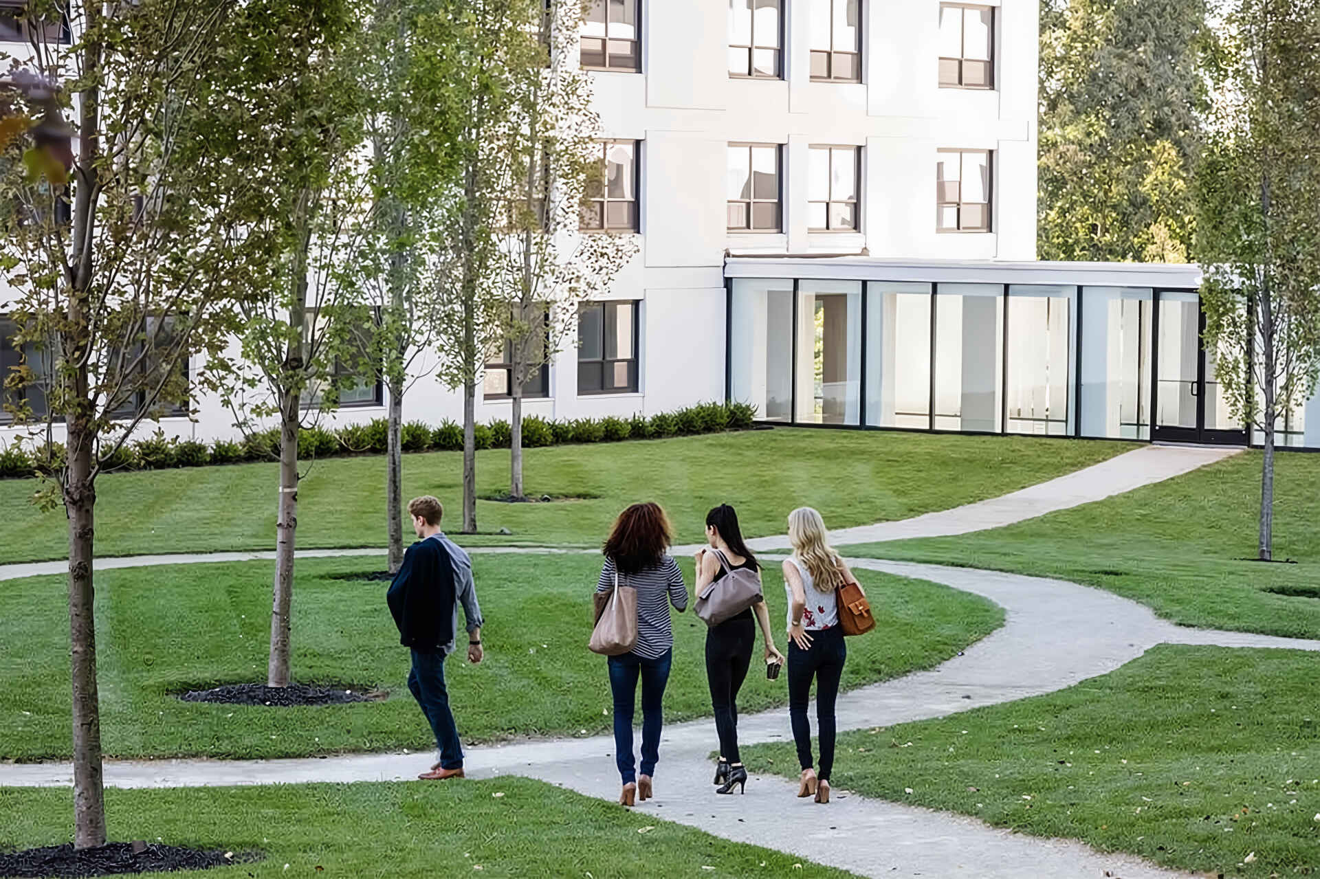Friends walking on a path through a community