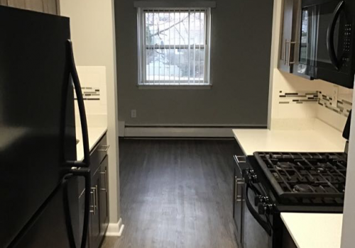 Kitchen with black appliances at Bromley House apartments for rent