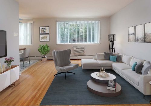 Living room with a couch, chair, and TV at Eola Park apartments for rent in Philadelphia, PA