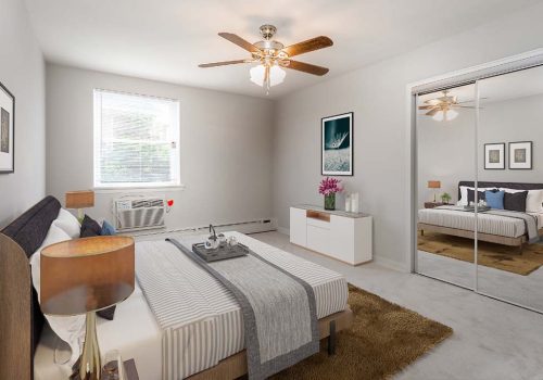 Fully furnished bedroom with a ceiling fan at Eola Park apartments for rent in Philadelphia, PA