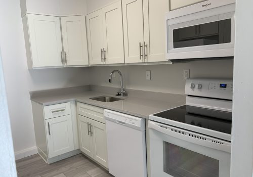 a kitchen with white cabinets and white appliances - Elkins Park terrace
