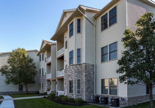 Exterior view of residential buildings at The Enclaves at Packer Park apartments for rent
