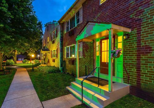 Entrance with lighting to building at night at Westgate Arms apartments in Jeffersonville, PA