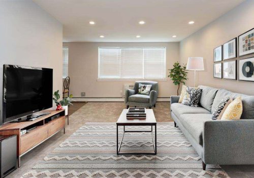 Large living room with a couch, chair, and TV at Willow Bend apartments for rent in Philadelphia, PA