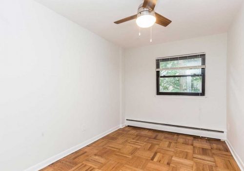 Bedroom with hardwood floors and window lighting at Sedgwick Terrace apartments for rent
